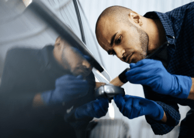 African american man car service worker applying nano coating on a car