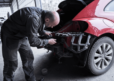 Car service worker repairs restores car